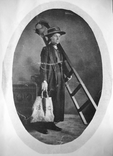 Lady carrying a ladder and canvas bag (initals 'B G C': Brentford Gaslight & Coke Company)